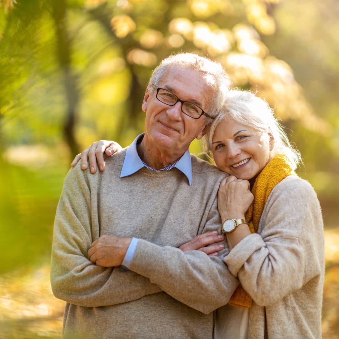 Happy senior couple in autumn park