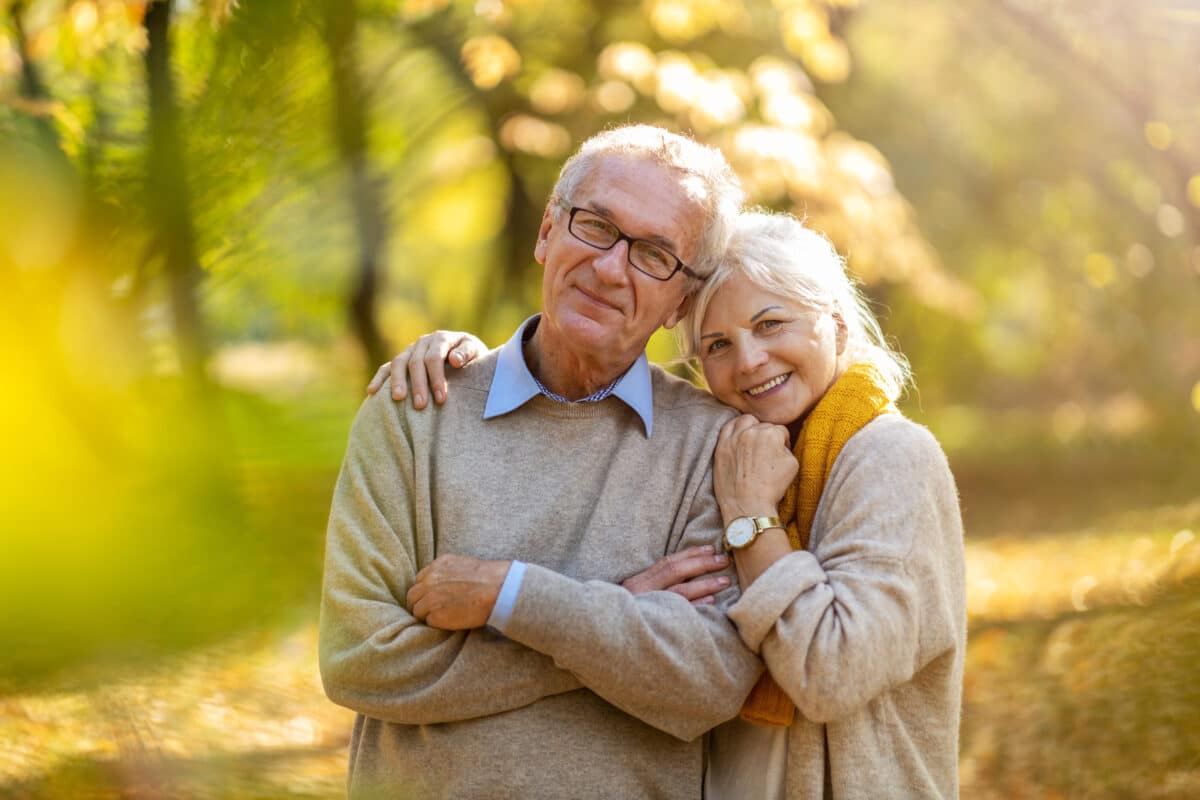 Happy senior couple in autumn park