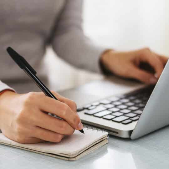 Businesswoman hand working with new modern computer and writing