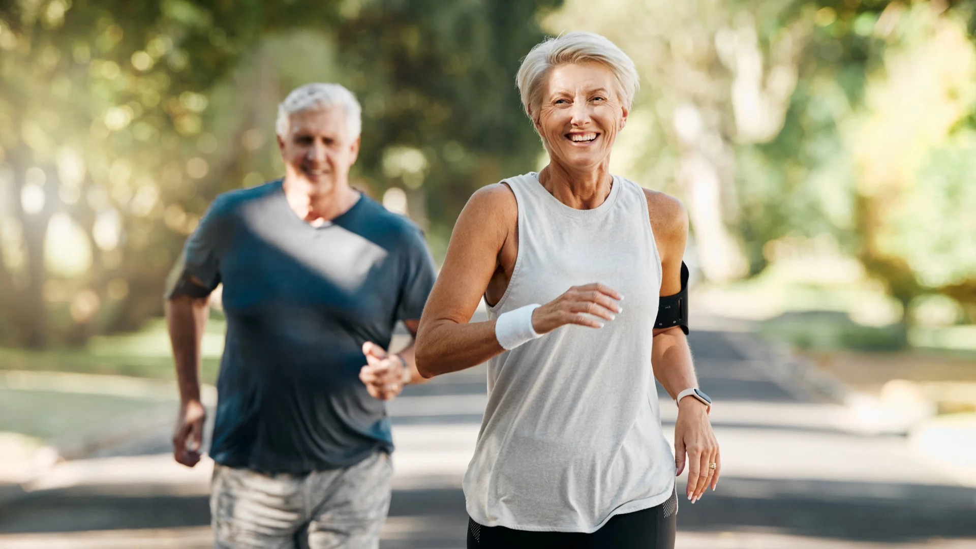 Senior couple jogging together outdoors