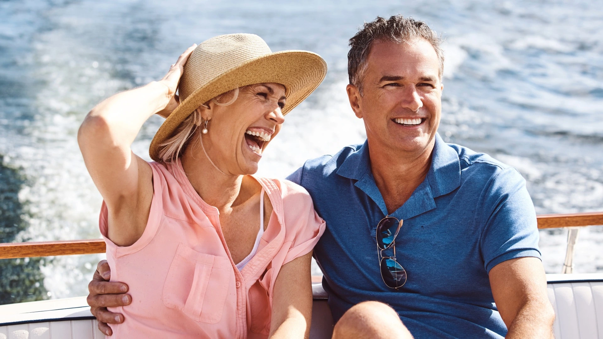 Middle-aged couple laughing on a boat